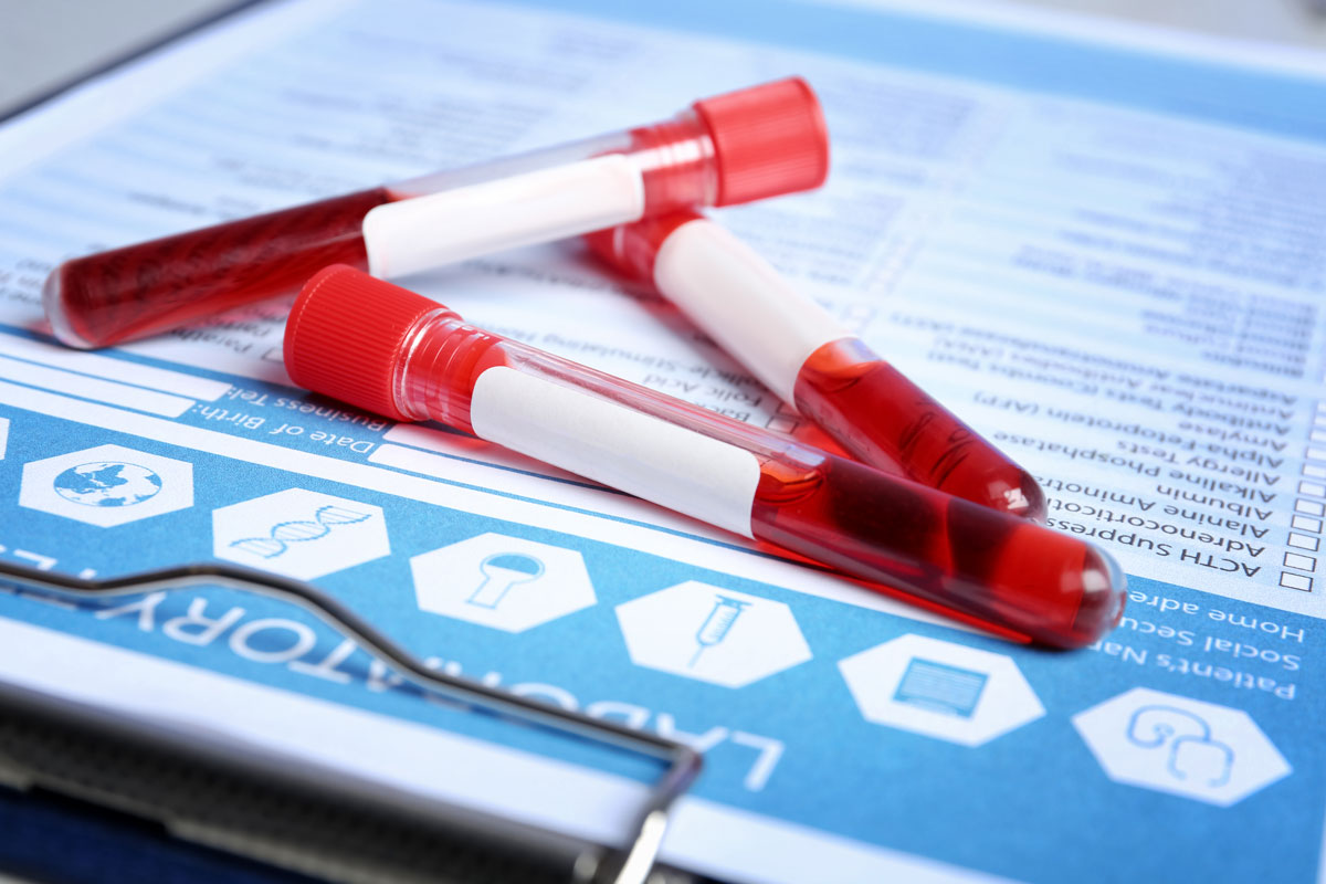 Lab technician reviewing test results on a screen